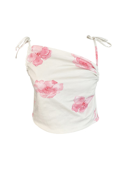 White organic cotton top with pink floral patterns on a white background